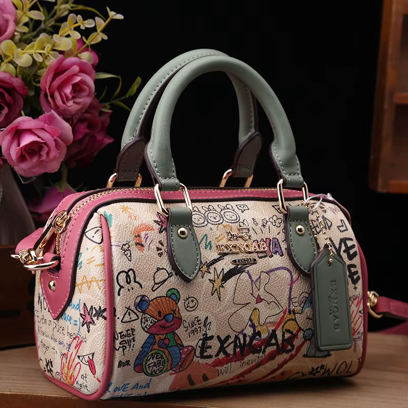 Sac Boston de luxe et vintage à porter à la main avec motifs graffiti de dessins animés tendance et cuir premium, sac bandoulière pour femme nouvelle tendance 2026